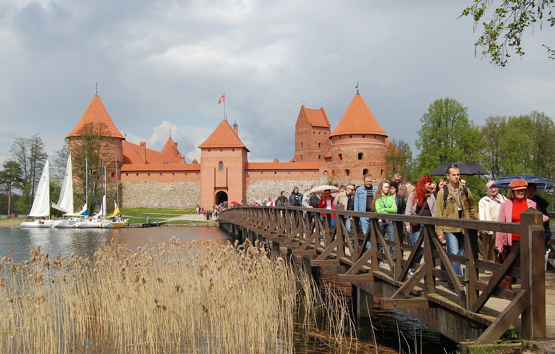 Trakai Island Castle with red brick towers reflected in Lake Galvė, Lithuania